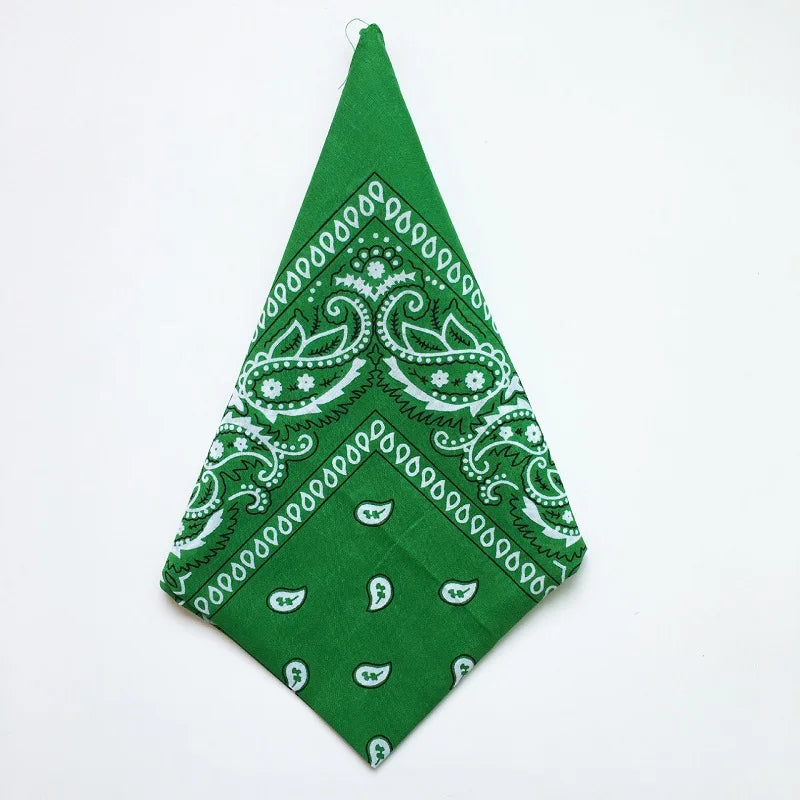 A green cotton bandana square scarf featuring an intricate white paisley print.