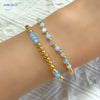 Gold-plated shell pearl beaded bracelet worn on a wrist.