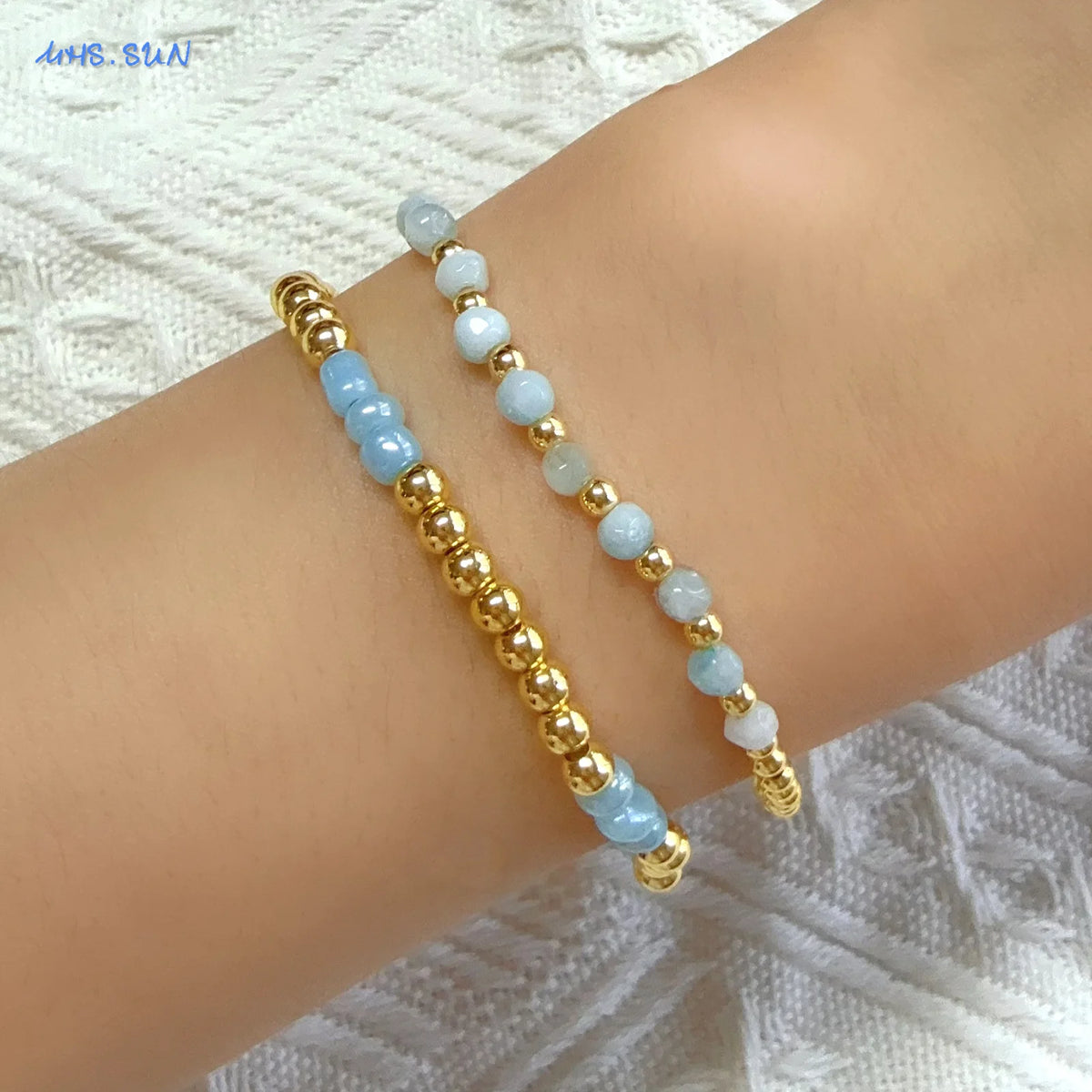 Gold-plated shell pearl beaded bracelet worn on a wrist.