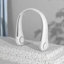 A white bladeless rechargeable electric neck fan is shown resting on a textured surface.