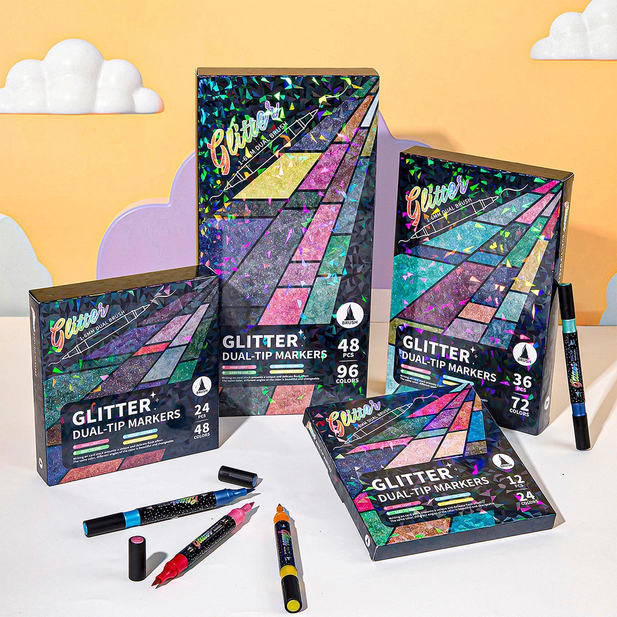 A collection of Glitter Dual-Tip Markers in various colors and packaging displayed against a yellow background.
