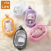 A collection of clear and pink mini bags and a white figure are displayed on a fluffy surface.