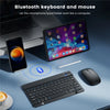 A portable Bluetooth keyboard and mouse setup shown with an iPad, smartphone, and a wireless mouse on a desk.