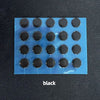 A blue sheet with multiple black adhesive dots, representing PTFE mouse skates for smooth gliding.