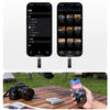 A hand holds a smartphone next to a high-speed NVMe SSD to USB Hub dock and a camera.