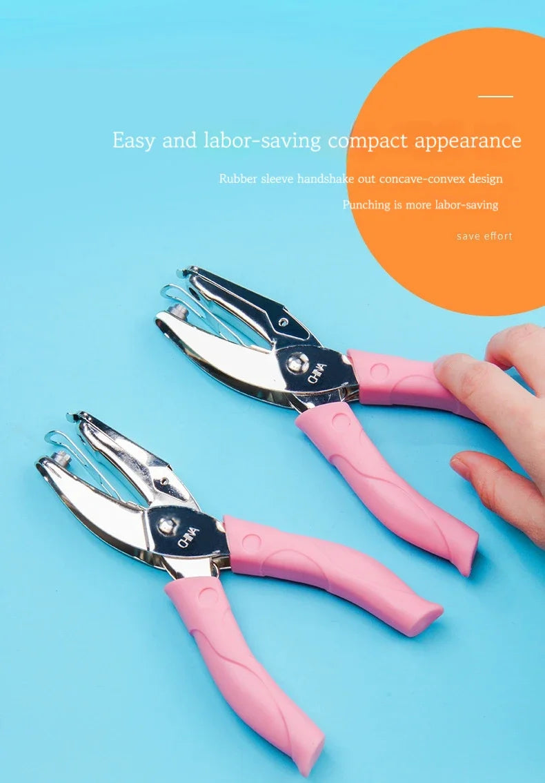 Two pink handheld metal punchers with rubber sleeves are shown against a light blue background.