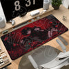 A gaming mouse pad featuring a dark, stylized illustration of characters on a red background.