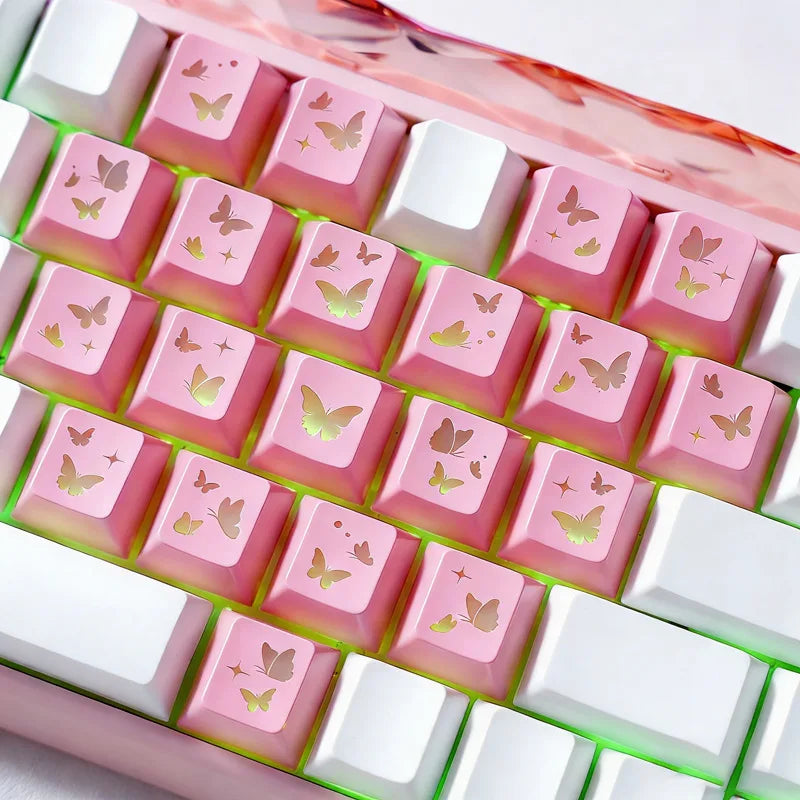 Rosa Schmetterling-Keycaps in einer Gitteranordnung in einer klaren Kunststoffhülle für mechanische Tastaturen