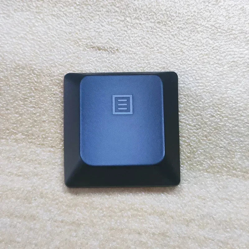 A dark blue replacement keycap for a Dell Alienware AW510K keyboard, shown against a light background.