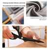 Close-up of professional stainless steel tailor scissors being used to trim fabric.