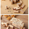 A collection of vintage wooden stamp seals and alphabet blocks arranged on a light brown paper background.