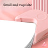 A pink precision corner cutter is shown next to a sheet of white paper.
