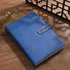 A blue A5 retro leather notebook with a gold-toned clasp resting on a wooden surface.