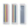 Three clear plastic containers hold various colored refillable woodworking marker pencils.
