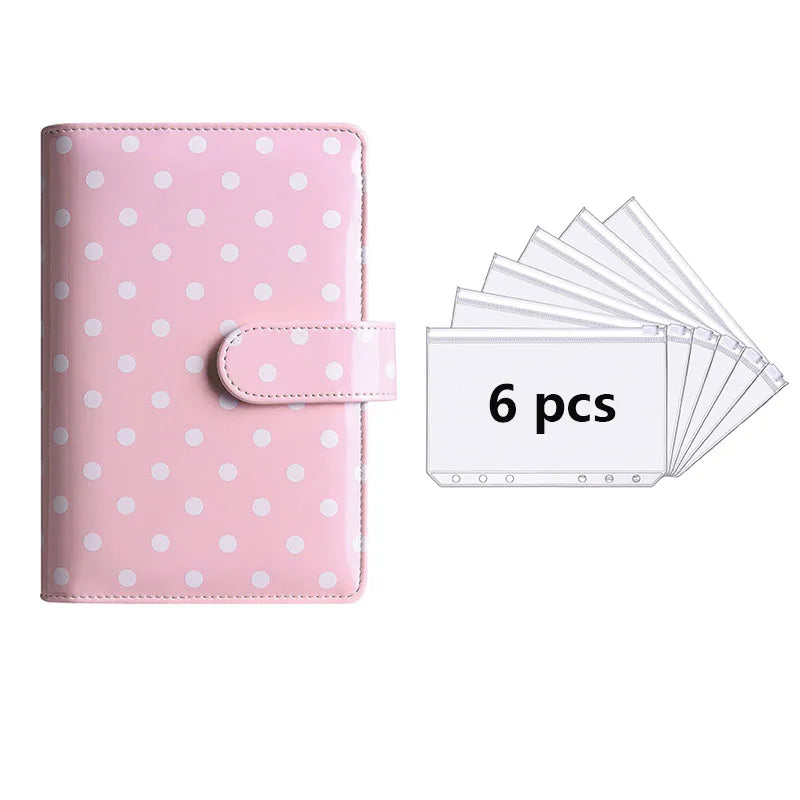 A pink reusable PU leather binder with white polka dots and a clear plastic sleeve containing six pages.