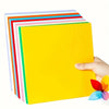 A stack of colorful cardstock sheets in various stripes and a bright yellow sheet being held by a hand.