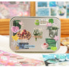 A silver metal case featuring various Y2K aesthetic cut film stickers on the lid.