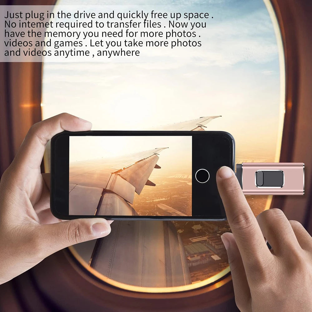 A hand holds a smartphone displaying a scenic view, with a USB flash drive inserted nearby.