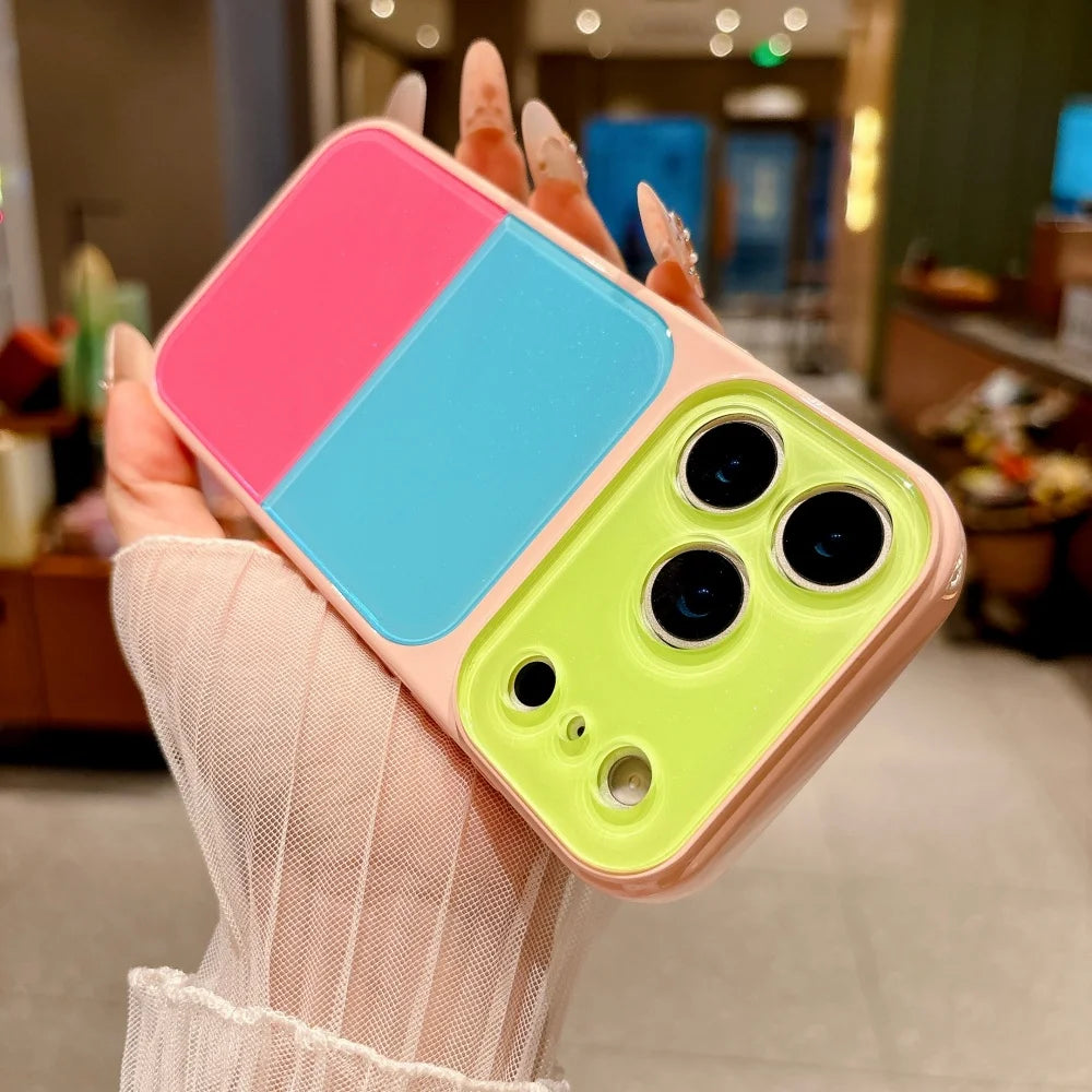 A hand holds a Dopamine Multicolor Block Acrylic phone case for iPhone featuring pink, blue, and lime green sections.