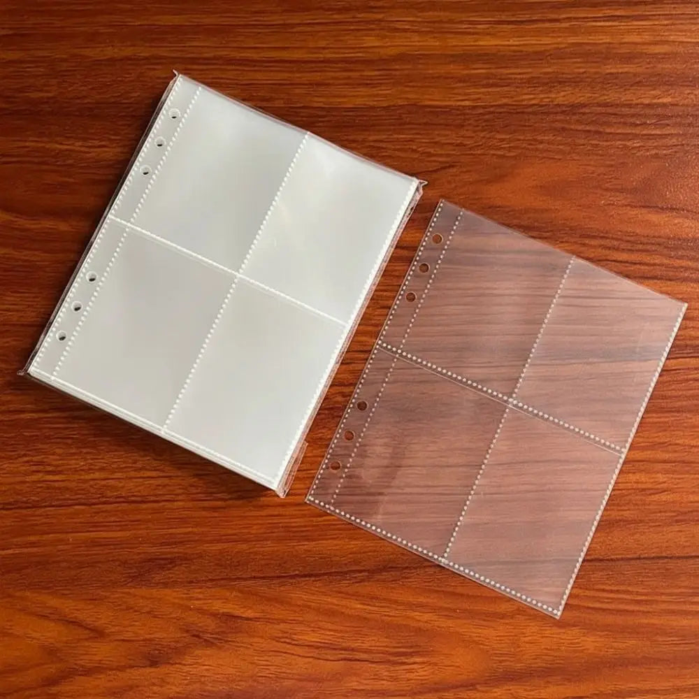 A set of A5 transparent photo card binder sleeves, some clear and some brown, laid on a wooden surface.