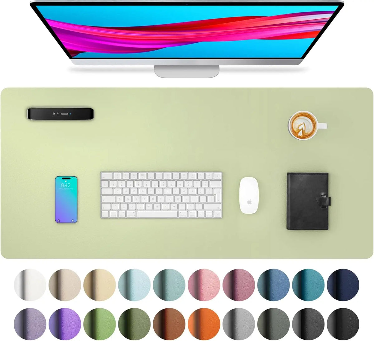 A large PU leather desk mat is shown with a laptop, keyboard, and mouse on a light green surface.
