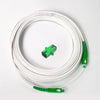 A coil of white single-mode fiber optic cable with green connectors.