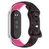 A pink and black silicone watch band with 3D engraved flowers for a Xiaomi smart band.