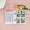 A pink A5 envelope budget binder set showing a challenge tracker and cash envelopes with US dollar bills.
