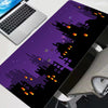 A purple and black gaming mouse pad featuring a vibrant, jagged print for a desk mat.