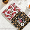 A clear protective case for an iPad featuring a pattern of red lips and leopard print.