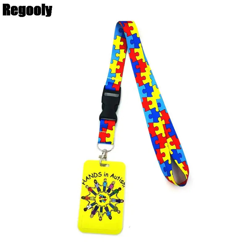 Buntes Puzzle-Teil-Muster-Lanyard mit gelbem Schlüsselring, der den Text 'Hands in Autism' trägt.