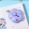 A purple floral design letter opener and paper cutter resting on a monthly planner page.