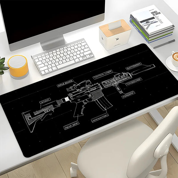 A black gaming mouse pad featuring a detailed silhouette of an assault rifle and related accessories on a white desk.