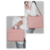 A woman is shown carrying a pink premium laptop sleeve for notebooks on her shoulder.