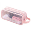 A pink transparent mesh pencil pouch containing cosmetic tools and makeup items.