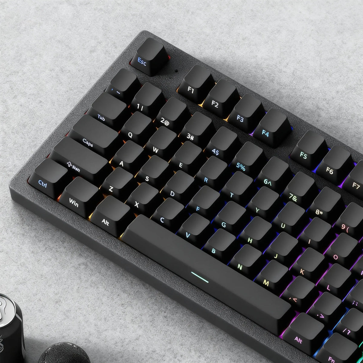 A close-up view of a black mechanical keyboard with PBT double-shot cherry profile keycaps and a wrist rest.