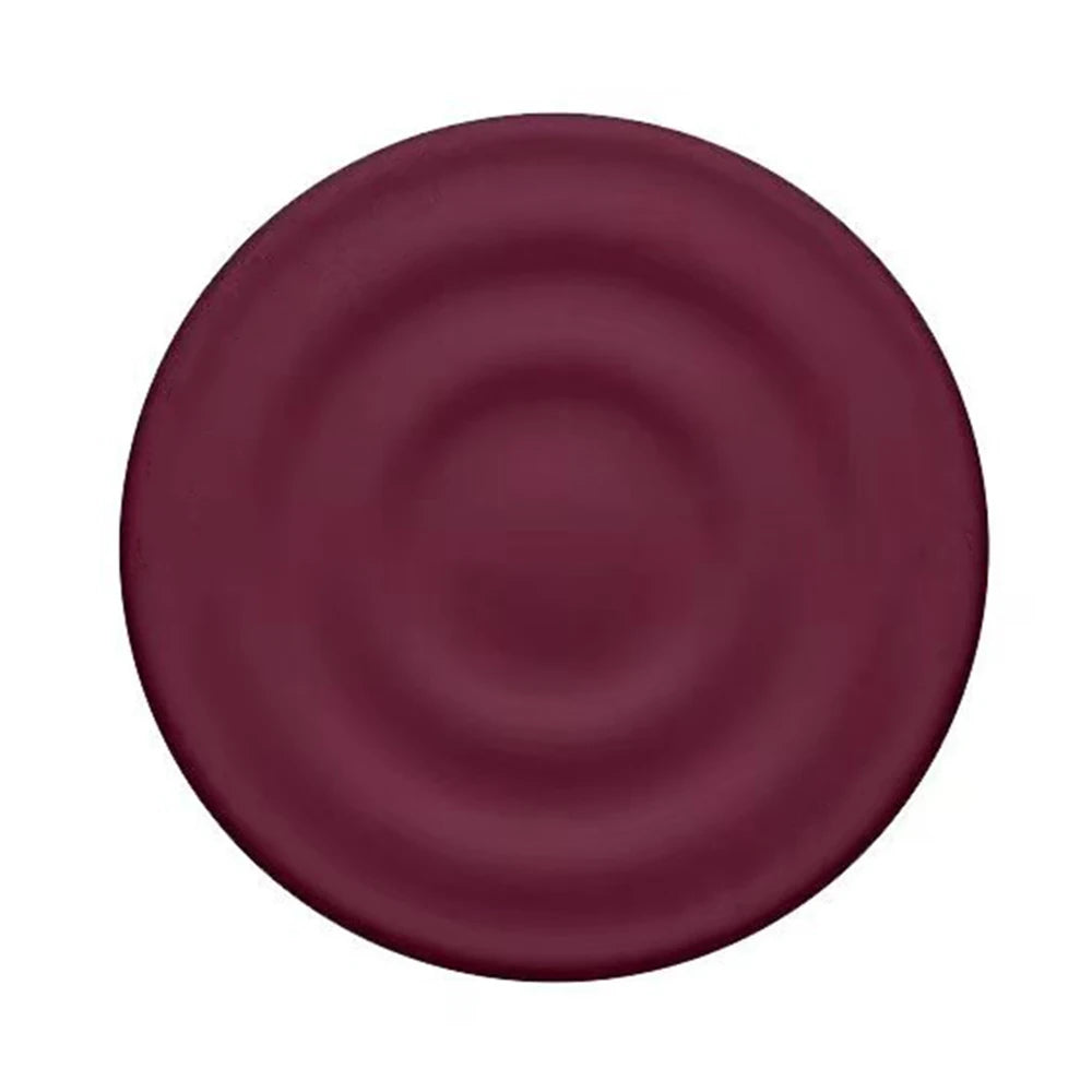 A round, deep plum colored silicone ripple grip magnetic phone stand.