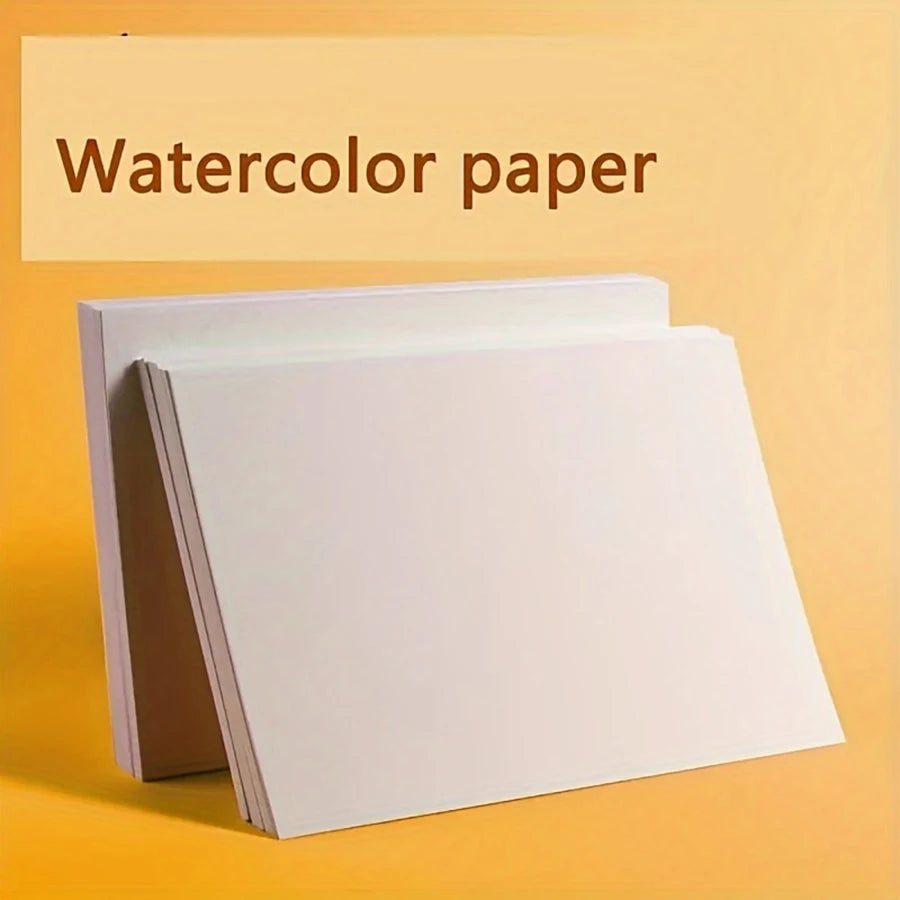 A stack of white watercolor paper pads is displayed on a yellow background.