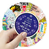A hand holds a circular arrangement of inspirational Bible verse stickers for notebooks and cups.