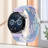 A silver smartwatch with a purple nylon watch strap displaying a dark screen and a digital watch face.
