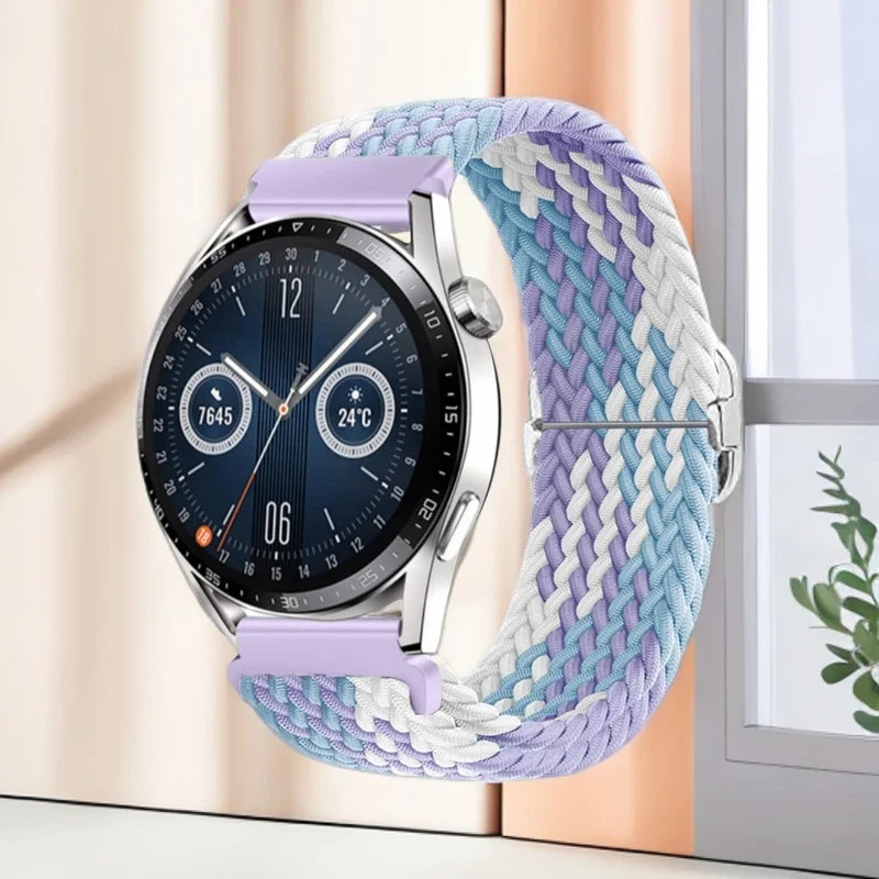 A silver smartwatch with a purple nylon watch strap displaying a dark screen and a digital watch face.