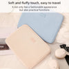A light blue and beige fabric laptop sleeve is shown resting on a white bed with a laptop and other accessories.