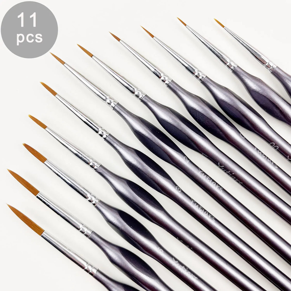 A set of eleven professional miniature paint brushes with ergonomic handles shown diagonally.