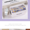 A box of decorative transparent washi tape rolls featuring purple and yellow floral patterns.