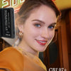 A young woman holds a portable clip-on LED selfie light, showcasing its features.
