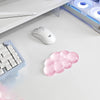 A white ergonomic cloud wrist rest is shown next to a keyboard and mouse on a white desk surface.