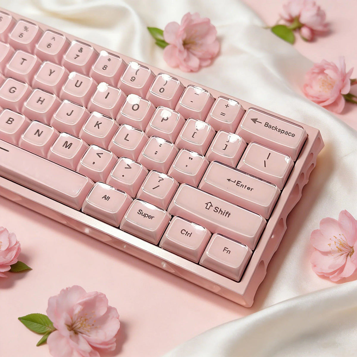 A close-up of pink crystal jelly side-printed keycaps for a mechanical keyboard resting on a soft fabric.