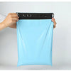 A hand is holding a light blue reusable waterproof poly shipping bag with a black measuring tape on top.