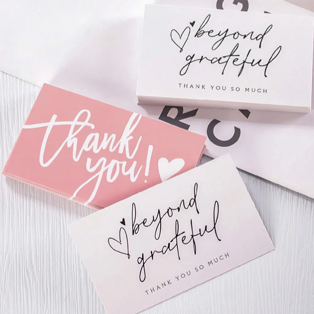 Pink and white thank you cards with handwritten text saying beyond grateful and thank you so much