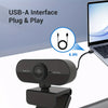 A black full HD mini webcam is shown connected to a laptop via a USB-A interface plug and play cable.